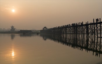 Sunrise over the U Bein Bridge crossing the Taungthaman Lake