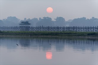 Sunrise over the U Bein Bridge crossing the Taungthaman Lake