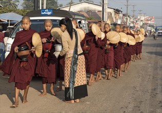 Monks on morning alms round in the streets of Mawlamyine