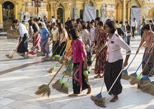 Burmese women sweeping the floor of the Shwedagon Pagoda