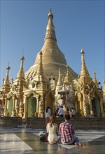 Young couple praying at Shwedagon Pagoda