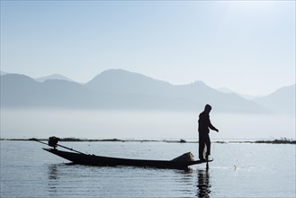 Intha fisherman with boat on Inle Lake