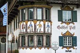 Luftlmalerei mural of various post riders at the bay window of the Hotel and Gasthof Zur Alten Post