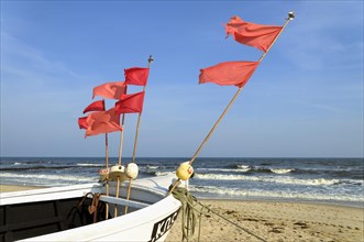 Fishing boat with red marker flags