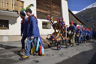 Parade of school boys with big bells