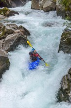 Kayakers in extreme whitewater