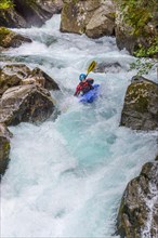 Kayakers in extreme whitewater