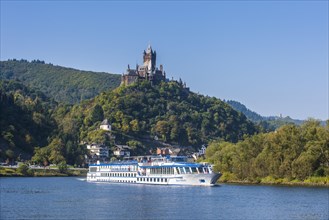 Cruise ship passing the Imperial Castle and the town of Cochem on the Moselle river