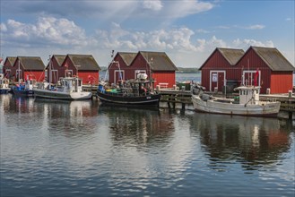 Red cottage with fishing boats