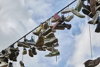 Shoes hanging from a wire