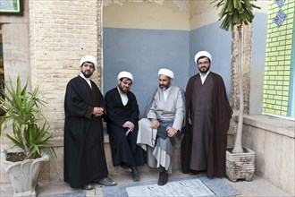 Four mullahs with turbans and long robes