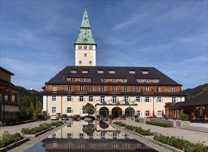 Schloss Elmau castle hotel with tower reflected in the fountain