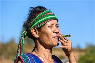 Man in traditional costume smoking cigar