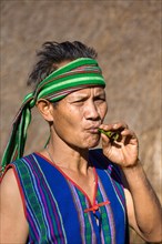 Man in traditional costume smoking cigar