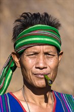 Man in traditional costume smoking cigar