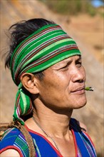 Man in traditional costume smoking cigar