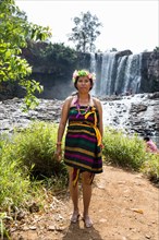 Phnong woman posing for tourists at the Bousra waterfall