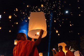 Monk letting sky lantern rise