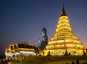 Illuminated Wat Huay Pla Kang temple at dusk