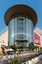Siam Paragon shopping mall with fountain in front of the glass facade