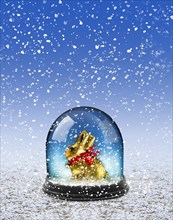 Chocolate Easter bunny in snow globe
