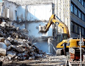 Building demolition with excavator