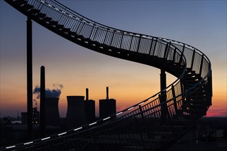 Power plant with part of the Tiger and Turtle sculpture at sunset