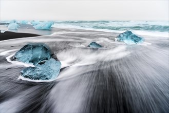 Glacial ice with ocean surf in the glacial lagoon Jokulsarlondes