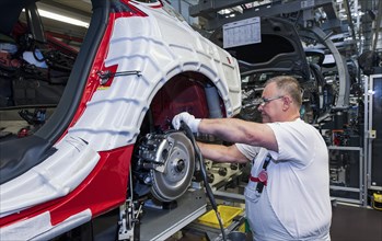 Audi technician assembling an Audi A6 on the production line