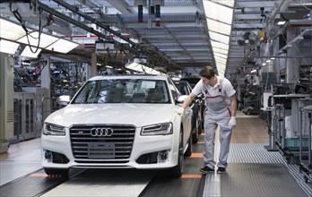 Audi AG employee conducting the first run of an assembled A8 sedan