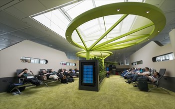 Passengers relaxing whilst waiting in a Recreation Area at Munich Airport