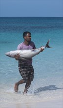 Fisherman carrying his freshly caught fish