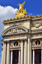 Facade with columns and gilded statue