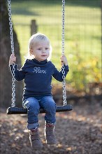 Toddler on a swing in the playground