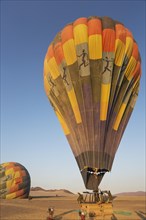 Pilot inflating hot air balloon with two burners