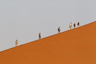 Tourists climbing Dune 45 in the Namib Desert