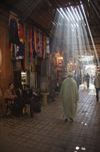 Sun rays filtering through beams at the souks of Marrakesh
