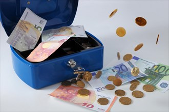 Cashbox with banknotes and coins