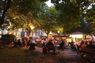 Beer garden in Adolfsallee under trees at dusk
