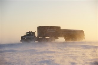 Truck transporting goods on the snowy Dalton Highway in the middle of the Arctic winter