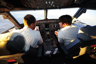 Pilot and copilot in cockpit