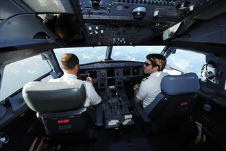 Pilot and copilot in cockpit