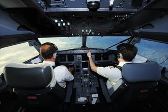 Pilot and copilot in cockpit