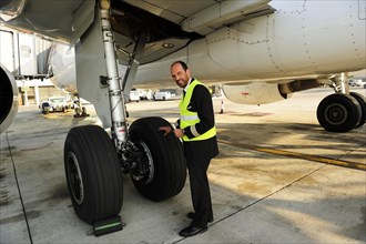 Pilot checking tyres and undercarriage