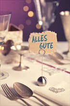 Note on festive table with the inscription Alles Gute or Best Wishes