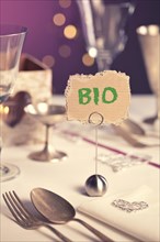 Note on festive table with the words Bio