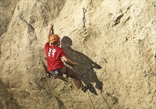 Climber lead climbing on a rock face