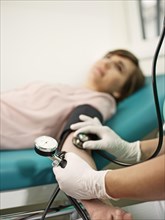 Nurse measuring patient's blood pressure