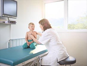 Pediatrician examining boy