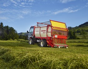Unitrac transporter with forage trailer collecting the dried hay